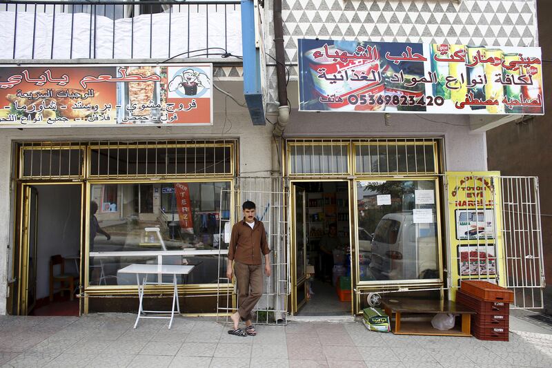 A Syrian who fled the war in his homeland outside Syrian-run shops in Ankara, Turkey. Reuters