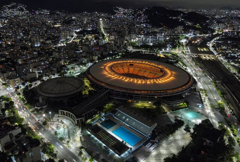 A drone photo shows the Maracana stadium illuminated with golden colours. EPA