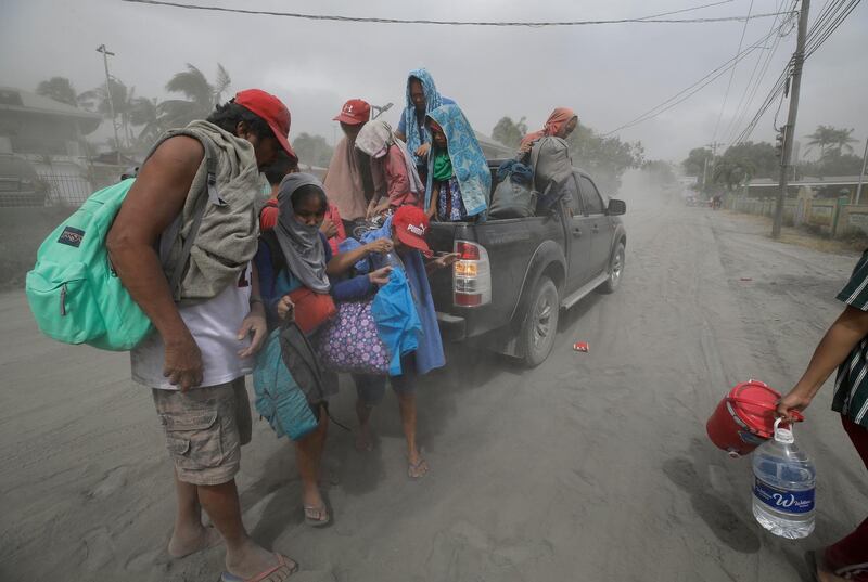 A family evacuates to safer grounds. AP Photo