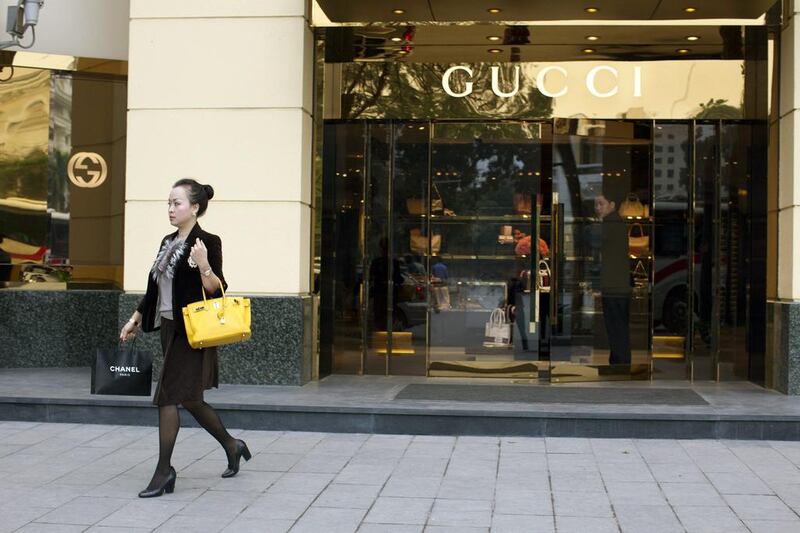 A Vietnamese woman walks out of the Gucci shop in the French quarter of Hanoi. Paula Bronstein /Getty Images

