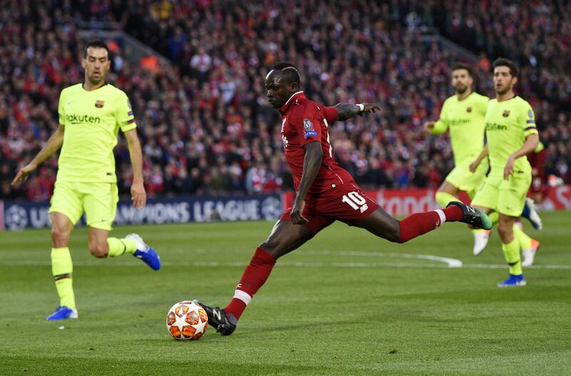 Sadio Mane stikes the ball at Barcelona's defence. EPA