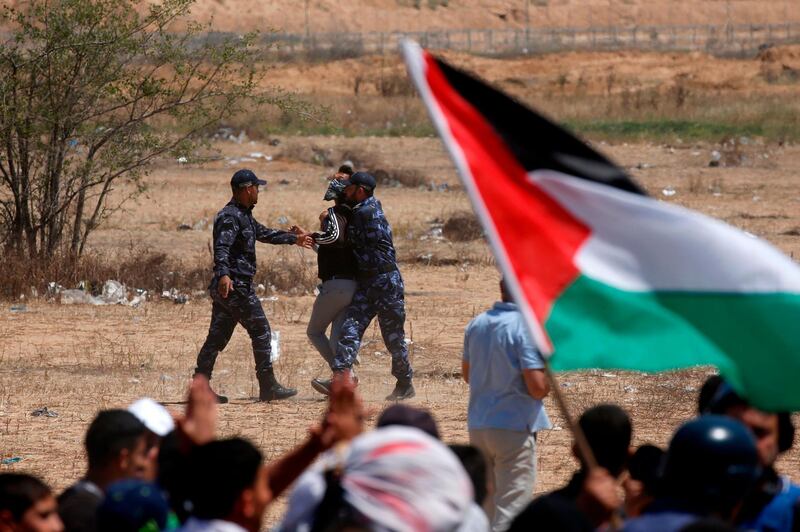 Palestinian Hamas police block protesters from reaching the border fence east of Khan Yunis in the southern Gaza Strip. AFP