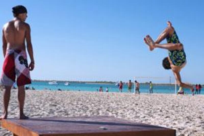 Wakeboard enthusiast Moe Barakji, 23, right, practises along the Corniche as Tony al Skik, 20, keeps an eye out.