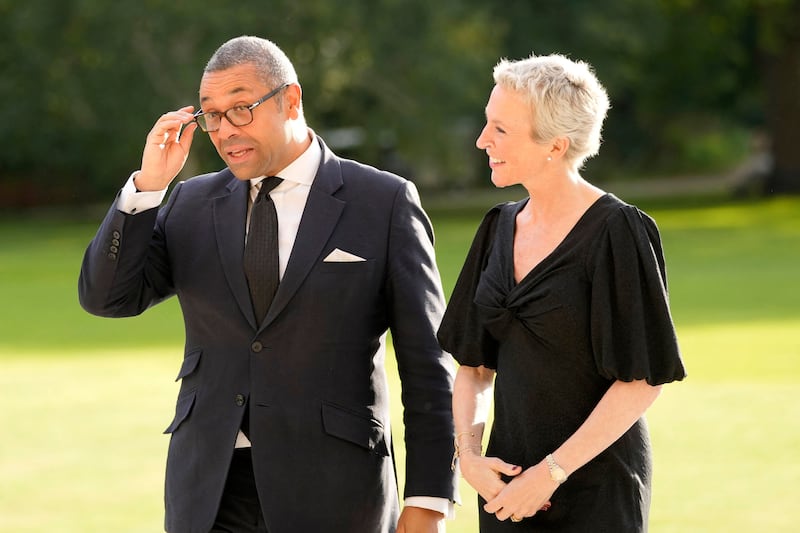 Britain's Foreign Secretary James Cleverly arrives at Buckingham Palace in London with his wife Susannah for the reception. AFP