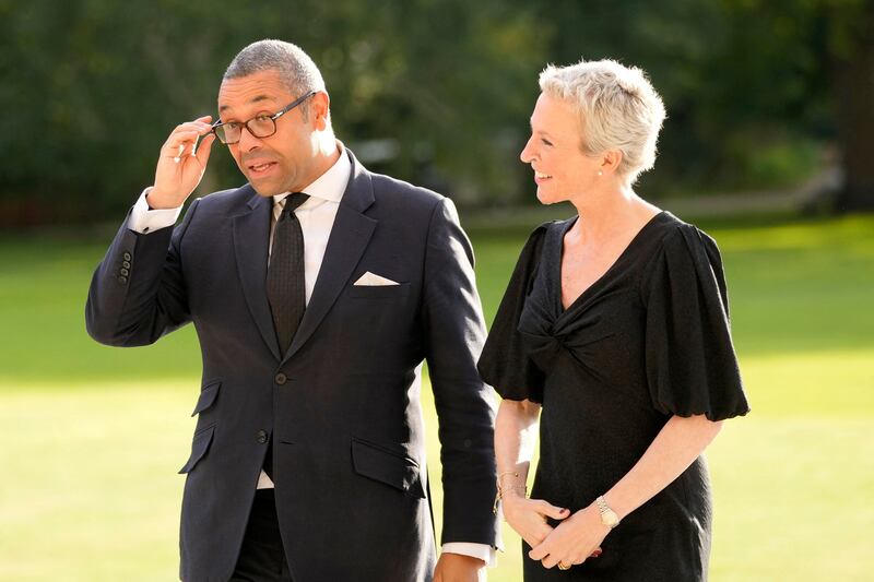 Britain's Foreign Secretary James Cleverly arrives at Buckingham Palace in London with his wife Susannah for the reception. AFP