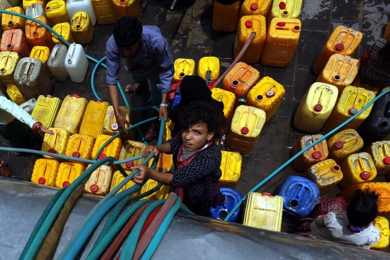 People collect clean water from a donated source in Sana'a, Yemen. EPA