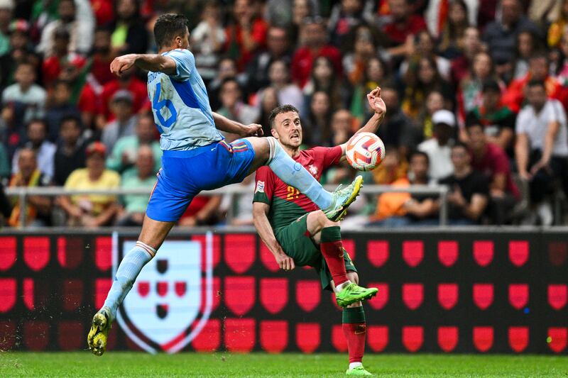 Portugal forward Diogo Jota and Spain midfielder Rodri challenge for the ball. Getty