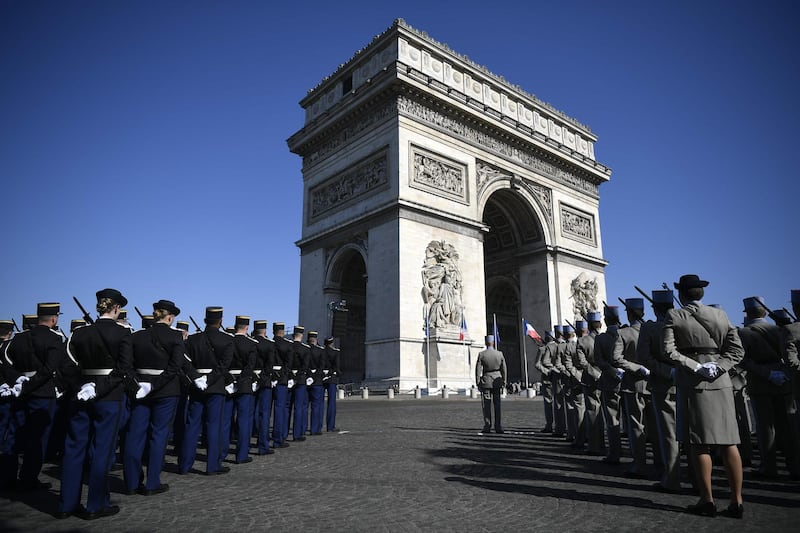 Soldiers stand under the Arc de Triomphe in Paris ahead of VE Day commemorations. Lionel Bonaventure / AFP