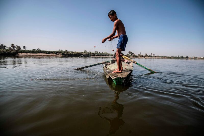 A young Egyptian fisherman pulls his net in the River Nile in Gabal al-Tear village near Minya city, 265km south of the Egyptian capital Cairo. Egypt has for years been suffering from a severe water crisis that is largely blamed on population growth.  AFP