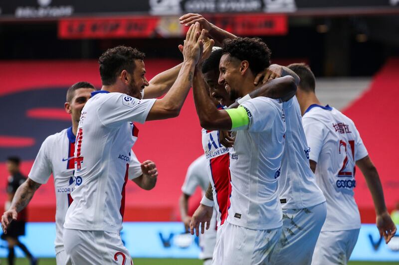 PSG's Marquinhos is congratulated by teammates after scoring. AP