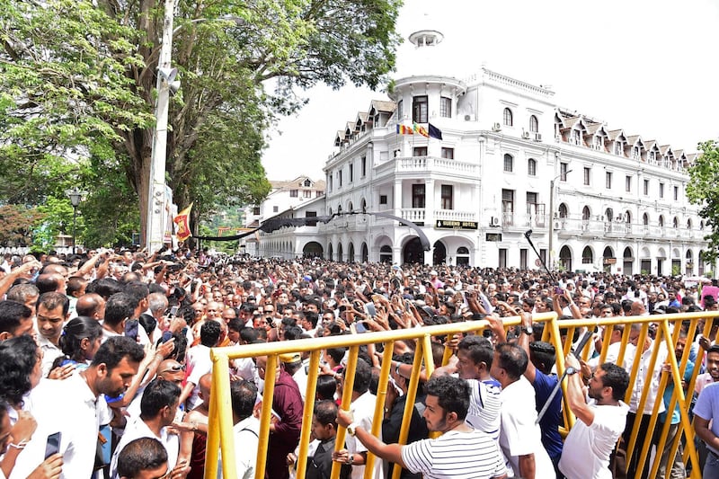Sri Lanka activists demonstrate outside the Buddhist shrine Temple of the Tooth in the central town of Kandy on June 3, 2019.  Demonstrations by several thousand people gripped Sri Lanka's pilgrim city of Kandy on June 3 as Buddhist monks demanded the sacking of three top Muslim politicians over the Easter suicide bombings. Shops and offices were closed in the city 115 kilometres (70 miles) east of Colombo as the crowd including several hundred monks rallied outside the famous Temple of the Tooth.
 / AFP / STR
