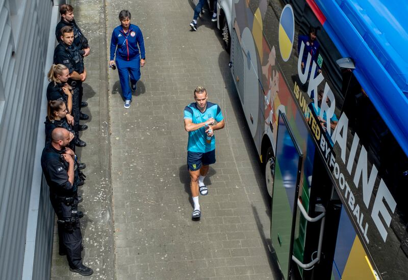 German police officers guard the Ukrainian team's bus after a public training session in Wiesbaden. AP