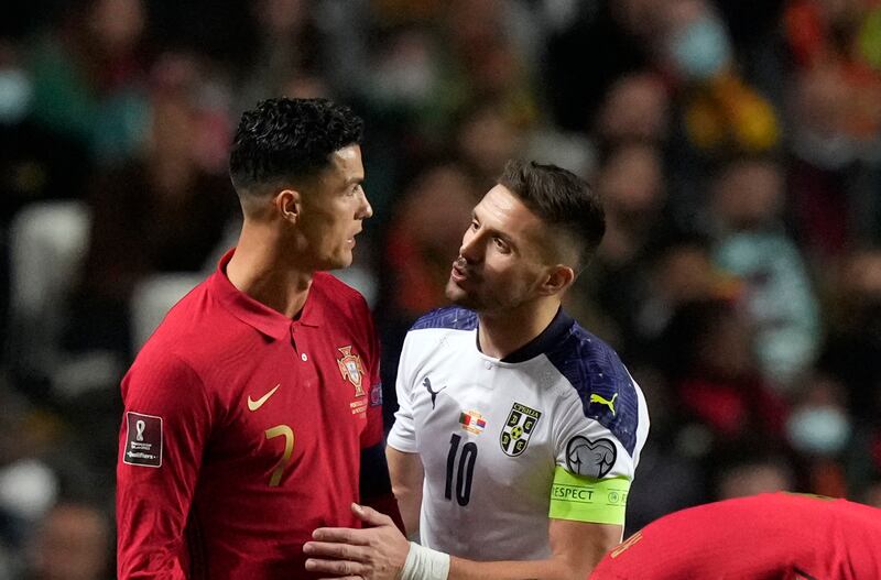 Portugal's Cristiano Ronaldo, left, talks with Serbia's Dusan Tadic. AP Photo