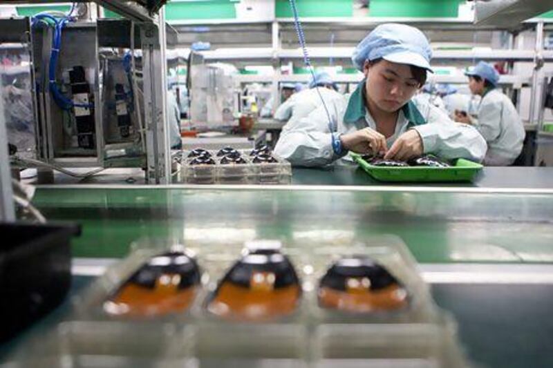 Workers assemble computer mice at a Logitech factory in Jiangsu Province. China has indicated that reform is on the cards. Nelson Ching / Bloomberg News
