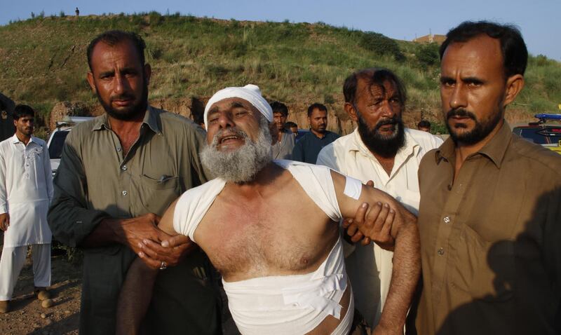 A man who was injured during a plane crash is helped. EPA