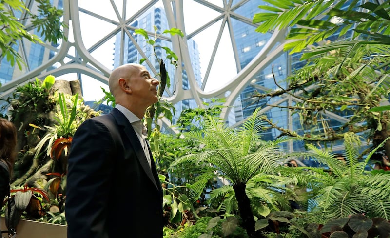 FILE - In this Jan. 29, 2018, file photo, Jeff Bezos, the CEO and founder of Amazon.com, takes a walking tour of the Amazon Spheres in Seattle. Bezos said Monday, Feb. 17, 2020, that he plans to spend $10 billion of his own fortune to help fight climate change. Bezos, the world's richest man, said in an Instagram post that he'll start giving grants this summer to scientists, activists and nonprofits working to protect the earth. (AP Photo/Ted S. Warren, File)