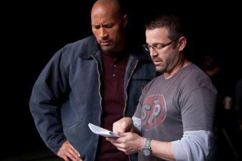 The actor Dwayne Johnson, left, and the director Ric Roman Waugh on the set of Snitch.