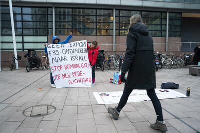 Protesters gather outside the court amid a suit that several aid and human rights organisations have filed against the Dutch state over weapons exports to Israel. EPA