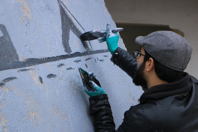 Al Shami draws a mural called 'Syria Game'. Abd Almajed Alkahr/The National
