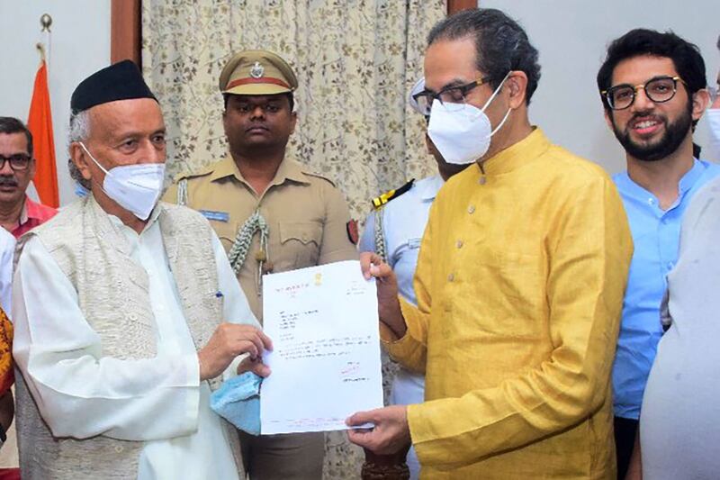 Uddhav Thackeray, right, the former chief minister of Maharashtra state, hands his resignation letter to state Governor Bhagat Singh Koshyari in Mumbai. AFP