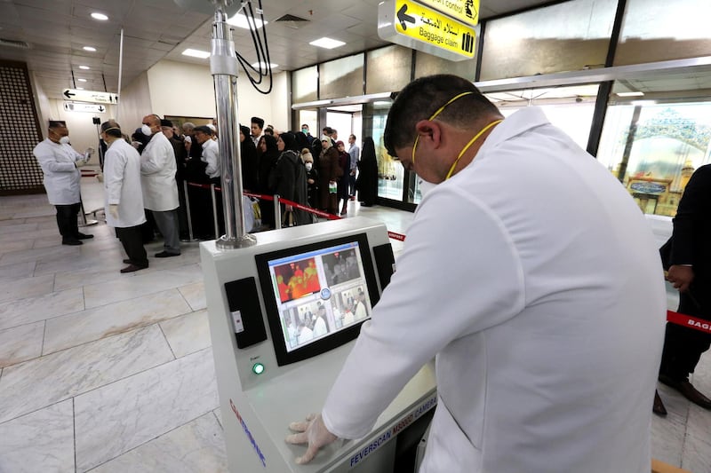 Members of Iraqi medical team check passengers upon arrival from Iran at Baghdad international airport in Baghdad, Iraq.  EPA