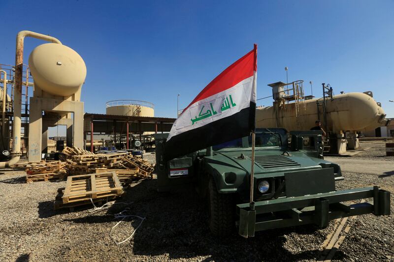FILE PHOTO: An Iraqi flag is seen on a military vehicle at an oil field in Dibis area on the outskirts of Kirkuk, Iraq October 17, 2017. REUTERS/Alaa Al-Marjani/File Photo