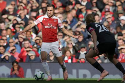 Arsenal's Aaron Ramsey, left, controls the ball in front of Everton's Tom Davis during an English Premier League soccer match between Arsenal and Everton at the Emirates Stadium in London, Sunday Sept. 23, 2018. (AP Photo/Tim Ireland)