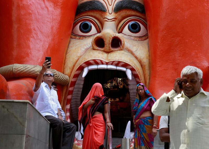 Hindus are seen outside the temple of Hindu Lord Hanuman in New Delhi. Cathal McNaughton / Reuters