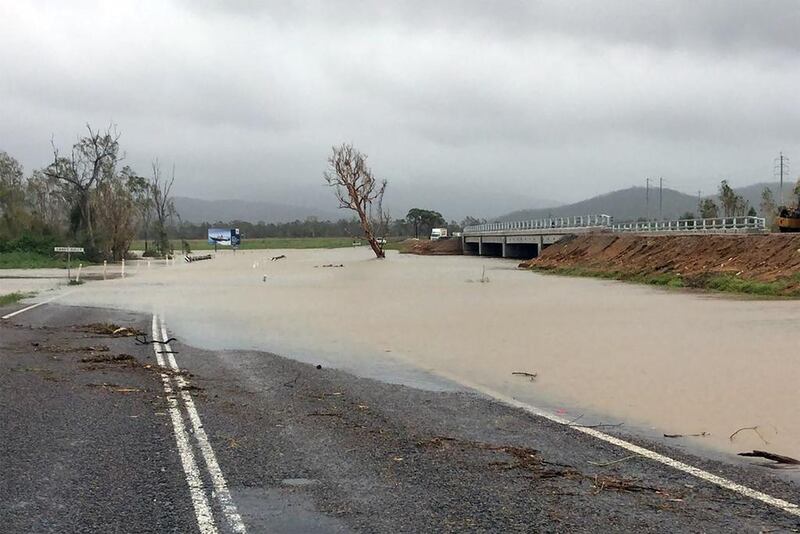 Flood waters submerging part of a highway near the Bowen area in Queensland that was hit by the powerful storm.  Handout from Queensland Police Service via AFP Photo
