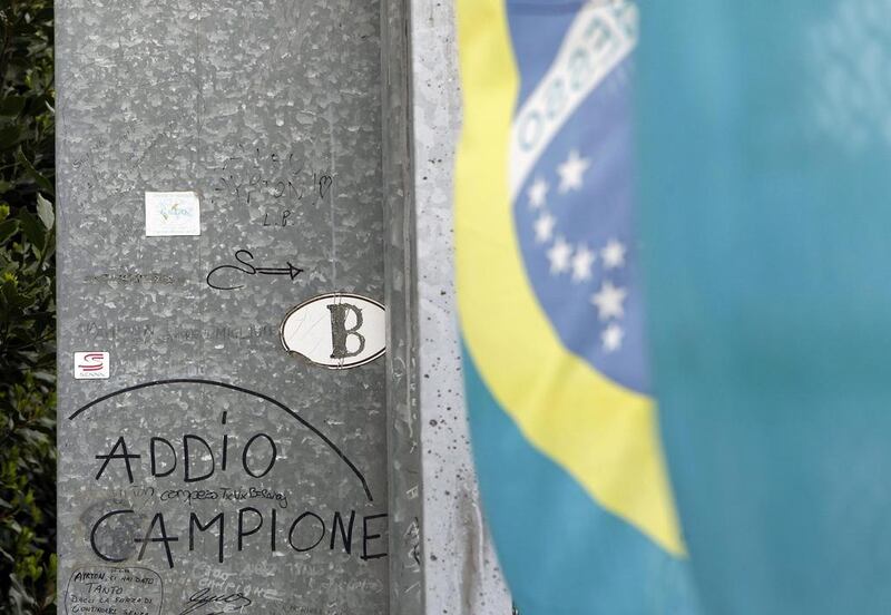 A message reads 'Addio campione' (Goodbye champion) on the fence at the site at Imola race track where Ayrton Senna died on May 1, 1994. Alessandro Garofalo / Reuters / April 30, 2014