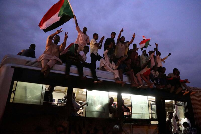 Flags are waved as people celebrate after the signature of the power sharing agreement. EPA/MORWAN ALI