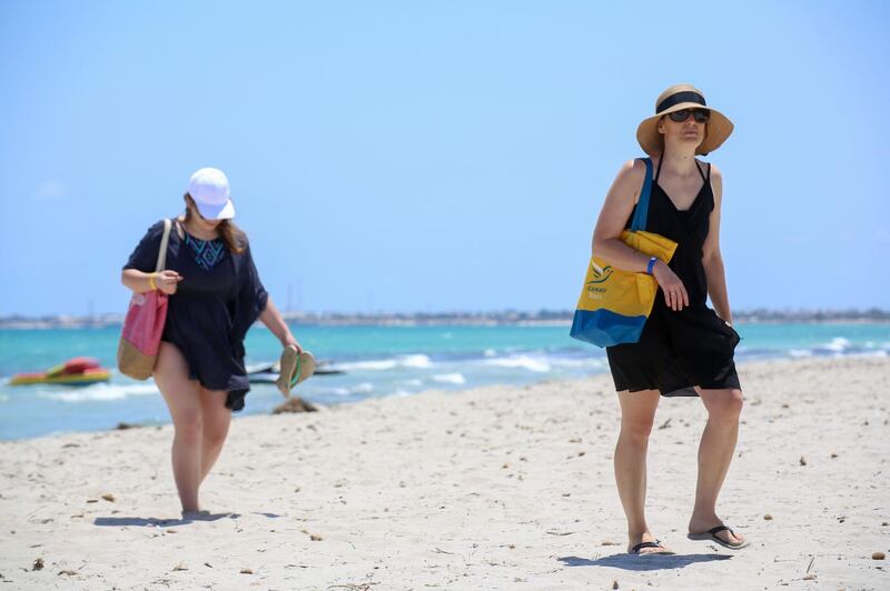 European tourists walk at the beach at a hotel on the Tunisian island of Djerba.  AFP