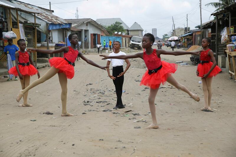 Ballet student Anthony Mmesoma Madu, centre, stands in position as fellow dancers perform in the street in Lagos, Nigeria. AP photo