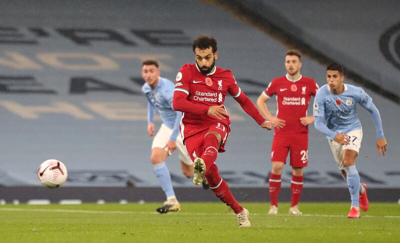 MANCHESTER, ENGLAND - NOVEMBER 08: Mohamed Salah of Liverpool scores his sides first goal from the penalty spot during the Premier League match between Manchester City and Liverpool at Etihad Stadium on November 08, 2020 in Manchester, England. Sporting stadiums around the UK remain under strict restrictions due to the Coronavirus Pandemic as Government social distancing laws prohibit fans inside venues resulting in games being played behind closed doors. (Photo by Martin Rickett - Pool/Getty Images)