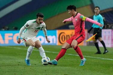 South Korea's Son Heung-min, right, fights for the ball with Iran's Amirhossein Hosseinzadeh during the final round of the Asian zone group A qualifying soccer match for the FIFA World Cup Qatar 2022 at Seoul World Cup Stadium in Seoul, South Korea, Thursday, March 24, 2022.  (AP Photo / Ahn Young-joon)