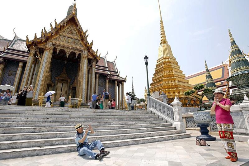 Chinese tourists at the Temple of the Emerald Buddha in Bangkok. A gratuity can be stretched a long way while traveling in South-east Asia. Rungroj Yongrit / EPA
