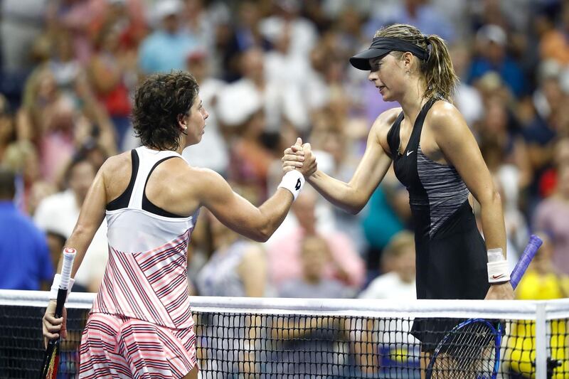 NEW YORK, NY - SEPTEMBER 03: Carla Suarez Nevarro of Spain shakes hands with her opponant Maria Sharapova of Russia following their women's singles fourth round match on Day Eight of the 2018 US Open at the USTA Billie Jean King National Tennis Center on September 3, 2018 in the Flushing neighborhood of the Queens borough of New York City.   Julian Finney/Getty Images/AFP
== FOR NEWSPAPERS, INTERNET, TELCOS & TELEVISION USE ONLY ==
