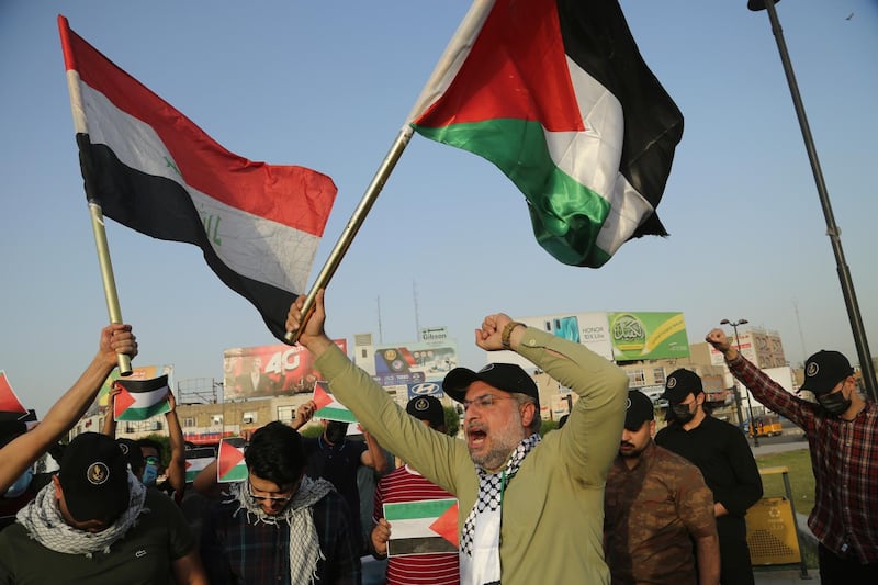 Protesters wave Iraqi and Palestinian flags during a demonstration against Israel's use of force against Palestinians, in Baghdad, Iraq. AP Photo
