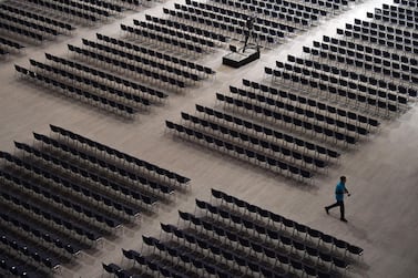 An employee walks between seats ahead of the Siemens company's annual shareholder's meeting in the Olympic hall in Munich, southern Germany. The European champion debate has been driven by the European Commission’s decision to block a rail merger between Siemens and Alstom. AFP