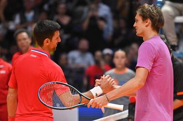 Serbia's Novak Djokovic (L) greets Germany's Alexander Zverev after the 2022 World Tennis League exhibition match at Dubai’s Coca-Cola arena in the United Arab Emirates, on December 20, 2022.  (Photo by Ryan LIM  /  AFP)