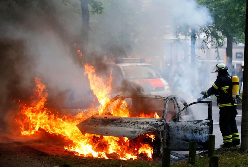 A firefighter works at the scene where a number of cars burnt down during the G20 summit in Hamburg, Germany, July 7, 2017. REUTERS/Hannibal Hanschke TPX IMAGES OF THE DAY