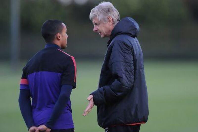 Prolonged discussions with Theo Walcott, left, has left Arsene Wenger frustrated.