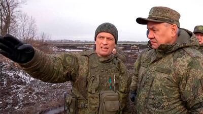 Russian Defence Minister Sergei Shoigu, right, listens to an officer on the front line in Ukraine. AP