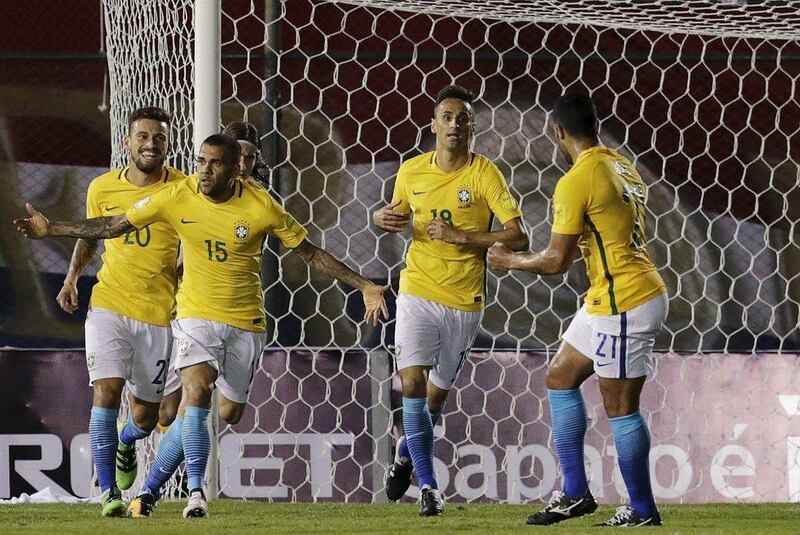 Dani Alves (15) of Brazil celebrates his goal near teammates. REUTERS/Mario Valdez