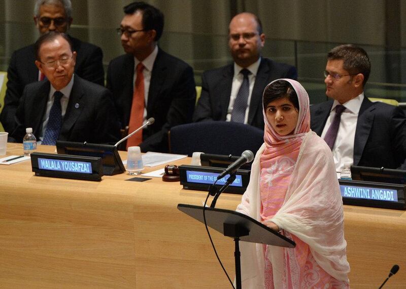 On July 13, 2013, Malala Yousafzai speaks before the United Nations Youth Assembly at UN headquarters in New York as UN Secretary General Ban Ki-moon, left, and Vuk Jeremic, right, President of the UN General Assembly listen. Stan Honda / AFP Photo