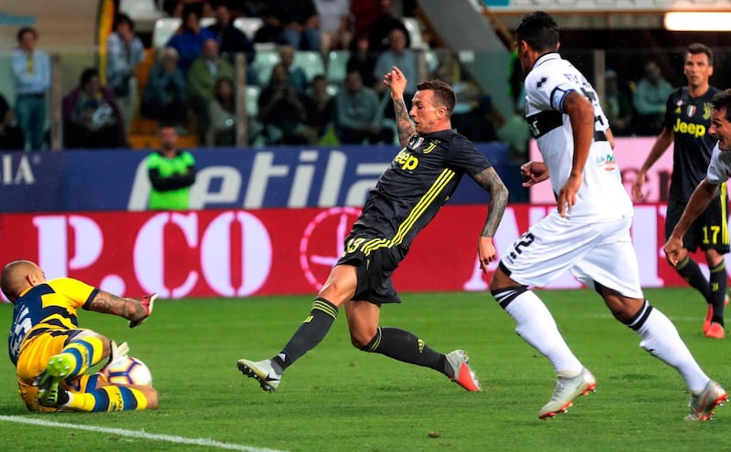 Parma goalkeeper Luigi Sepe, left, saves a shot from Federico Bernardeschi. AP Photo