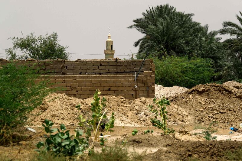 Gold mining residues are piled up near a residential area in the village of Banat, north of the Sudanese capital Khartoum. AFP 

