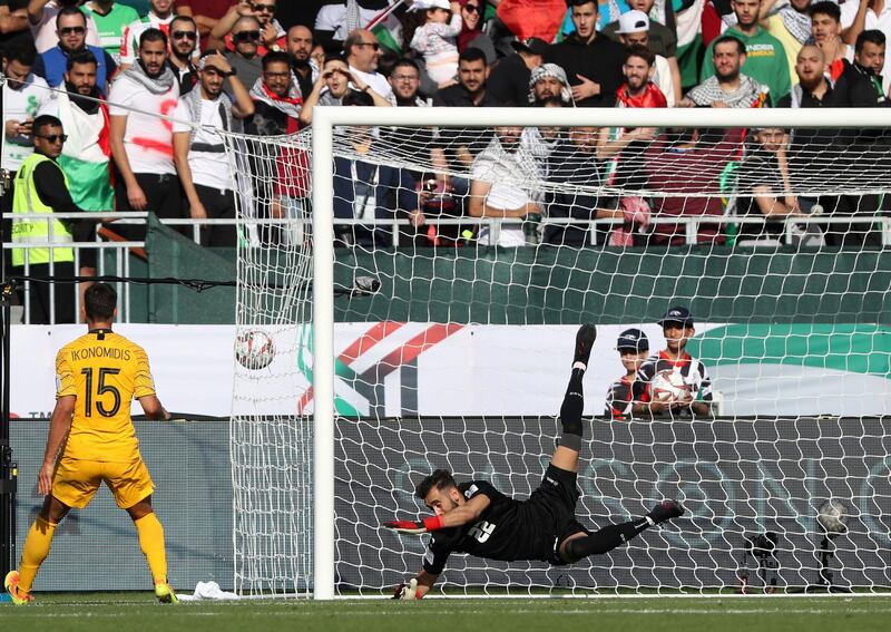 Palestine's goalkeeper Rami Hamadi fails to catch the ball as Australia scores. AFP