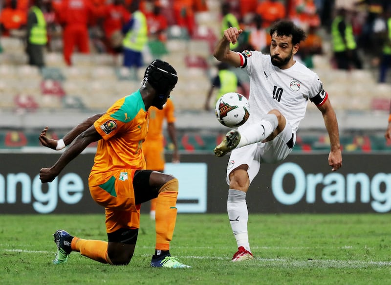 Ivory Coast's Eric Bailley attempts to block a Mohamed Salah pass. Reuters