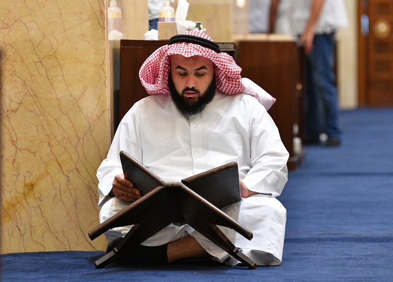 A Muslim worshipper reads the Holy Quran on Laylat al-Qadr at Majidul Kabeer Grand Mosque in Kuwait City, Kuwait. EPA